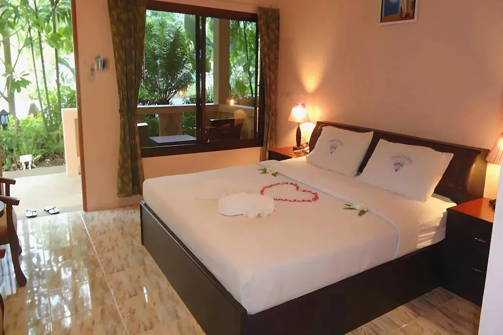 A bright double room with tiled floors and a garden window
