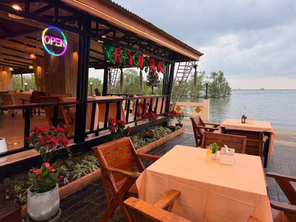 Open-air tables on the beachfront restaurant deck