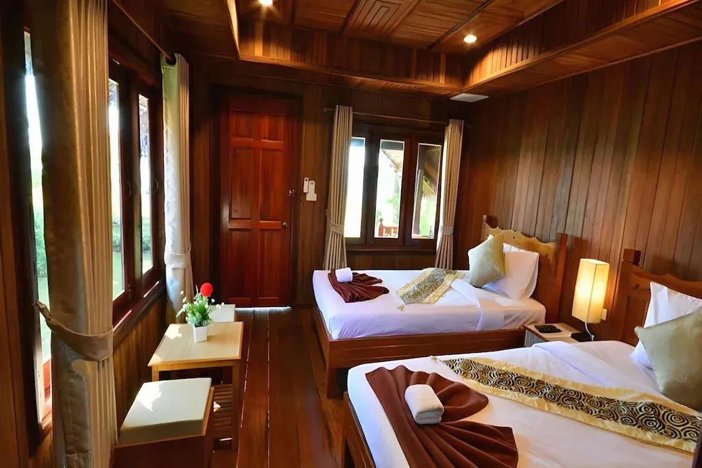 Twin beds in a teak-panelled cottage