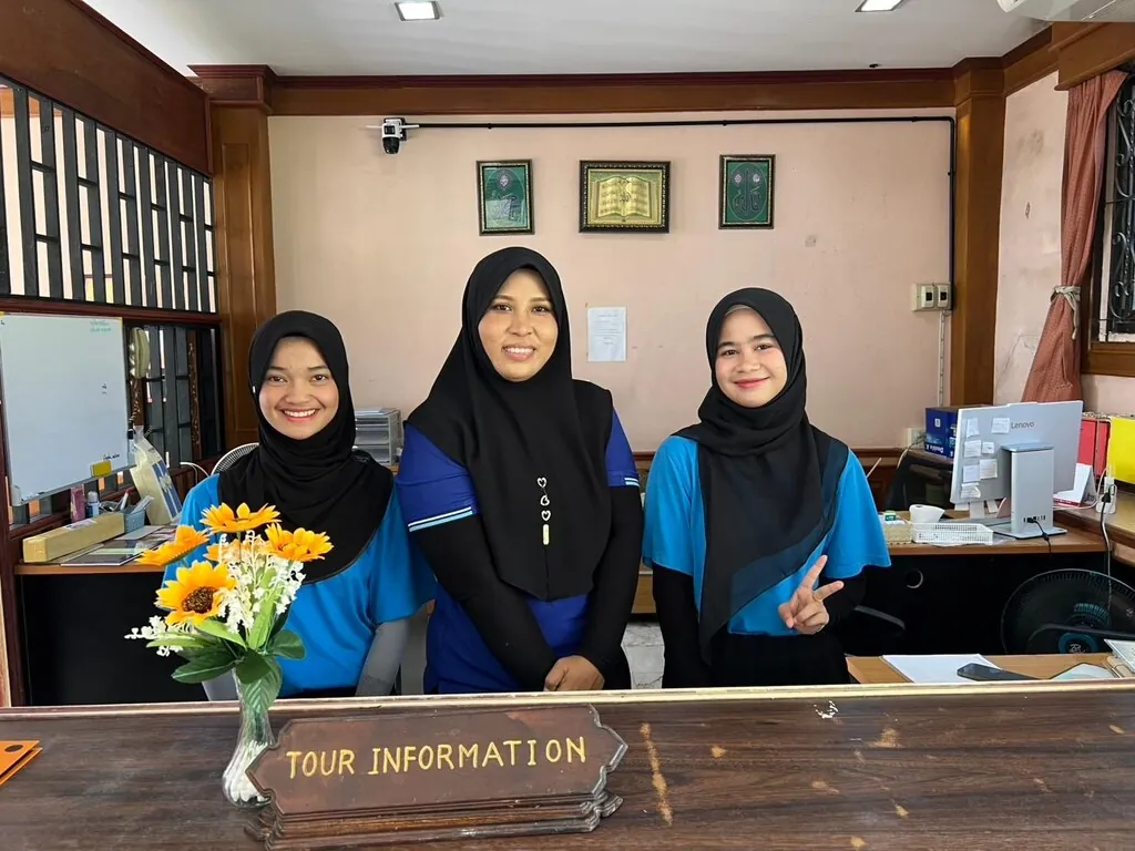 Three smiling members of the front-desk team